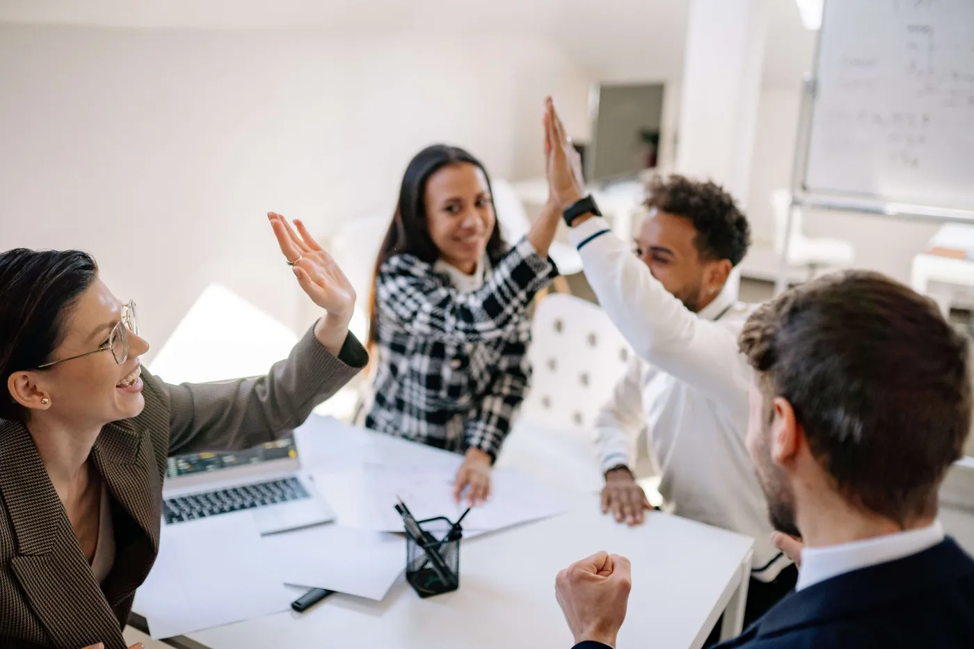 High five between team members to celebrate creating a repeatable, scalable compliance program